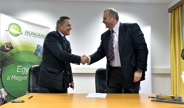 Ionel Ghita, a román Softronic vállalat vezérigazgatója (b) és Horváth László, a LAC Holding elnök-vezérigazgatója kezet fog a magyarországi mozdonygyártás indításáról szóló szándéknyilatkozat aláírásán Budapesten.